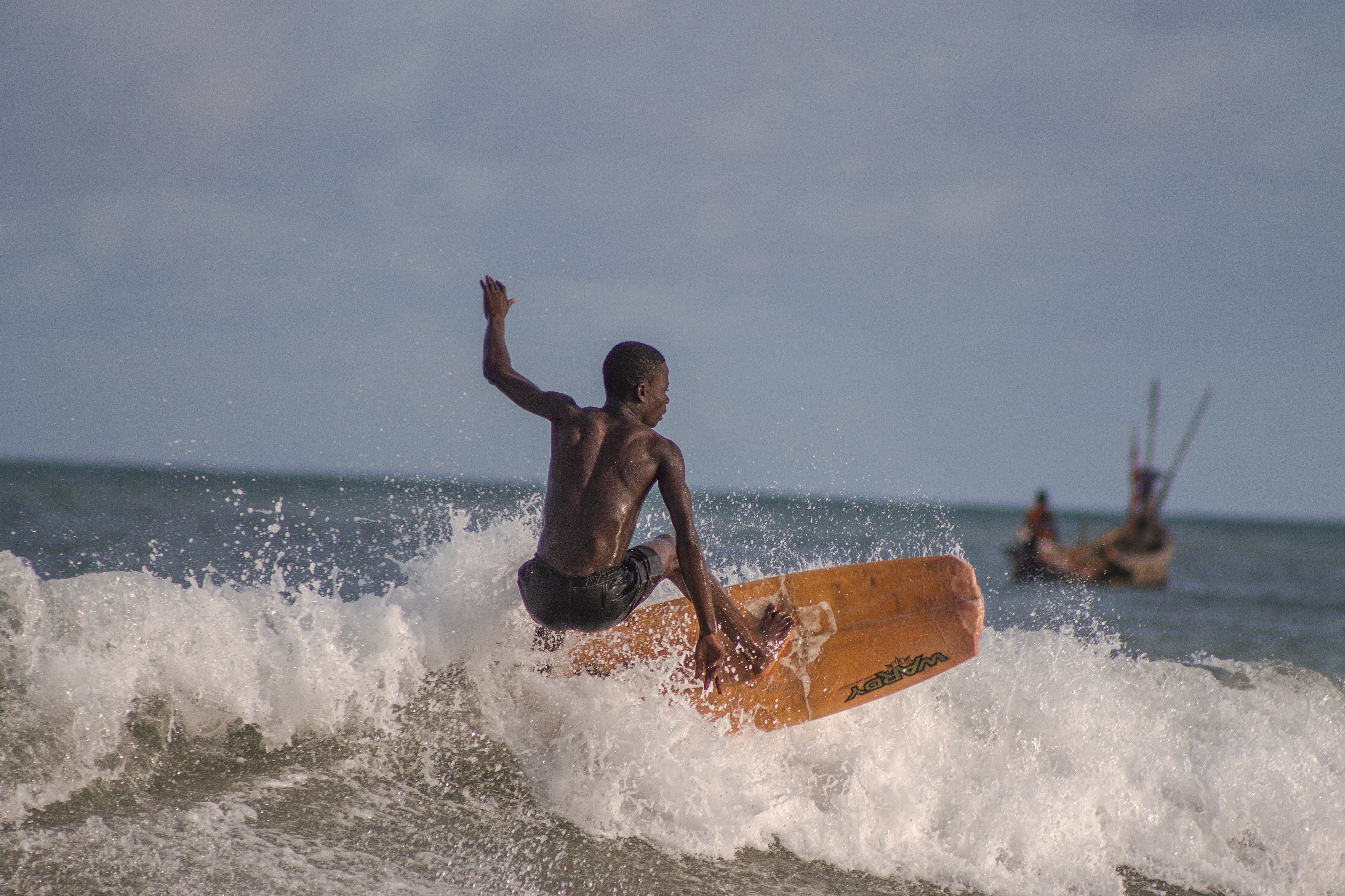 Surfers in the waves on Ghana's coast